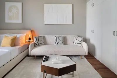 a living room with a couch and a coffee table at Studio Nova at Dubai Sports City in Dubai
