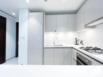 a white kitchen with white cabinets and a sink at Stunning 2-Bed Home in Sobha Creek Vistas in Dubai