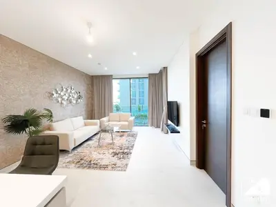 a living room with a couch and a table at Stunning 2-Bed Home in Sobha Creek Vistas in Dubai