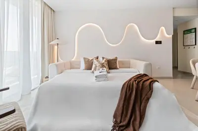a large white bedroom with a large white bed at 41st-Floor 2BR with World's Highest Running Track in Dubai