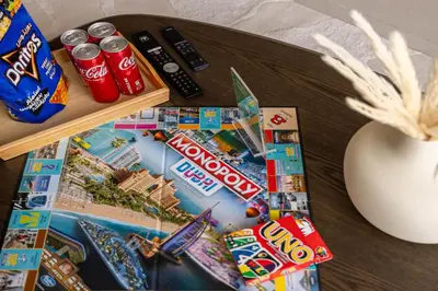 a table with snacks and a magazine on it at 41st-Floor 2BR with World's Highest Running Track in Dubai
