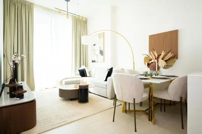 a living room with a white couch and a table at Onyx 1BR with Stunning City Views in Dubai