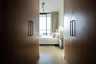 a room with a bedroom with a bed and a door at Luxury 1BR on High Floor JVC in Dubai