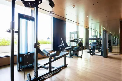 a gym with treadmills and ellipticals in a building at Elegant 1BR with High Rise JVC in Dubai
