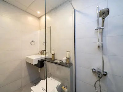 a bathroom with a shower and a toilet and a sink at Bright and Spacious 1 Bed Prime JVC Location in Dubai