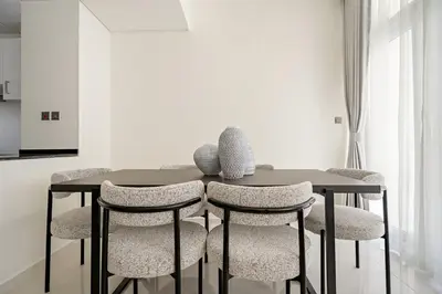 a dining room with a table and chairs at Tranquil 3BR Villa with Malibu Beach Access in Dubai