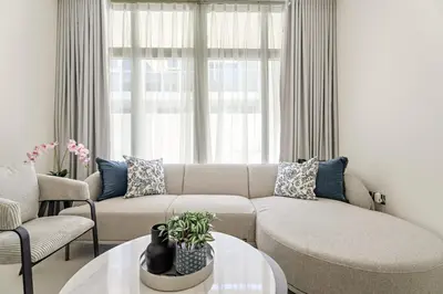 a living room with a couch and a table at Tranquil 3BR Villa with Malibu Beach Access in Dubai