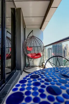 a room with a table and chairs on a balcony at IDLE 1Bed Marina POOL &JBR BEACH in Dubai