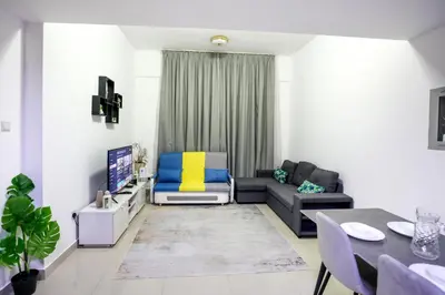 a living room with a couch and a table at IDLE 1Bed Marina POOL &JBR BEACH in Dubai