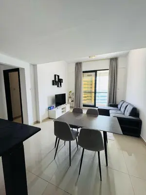 a living room with a couch and a table and chairs at IDLE 1Bed Marina POOL &JBR BEACH in Dubai