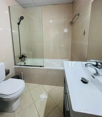 a bathroom with a toilet and a sink and a tub at IDLE 1Bed Marina POOL &JBR BEACH in Dubai