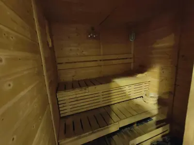 a wooden sauna with a bench in the middle at Modern Studio with free Netflix - Close to Metro in Dubai