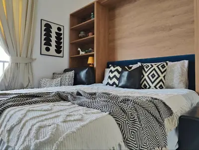a bedroom with two beds with pillows on them at Modern Studio with free Netflix - Close to Metro in Dubai
