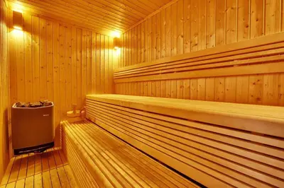 a sauna with wood paneled walls and a wooden floor at Charming Studio Retreat -Few steps away from Ocean in Dubai