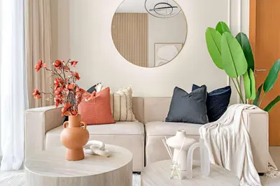 a living room with a couch and a table at Silkhaus 1BDR Holiday Stay at Pantheon Elysee in JVC in Dubai