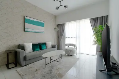 a living room with a couch and a table at Nasma Luxury stays - Executive stay in the Heart of Dubai Financial Hub in Dubai