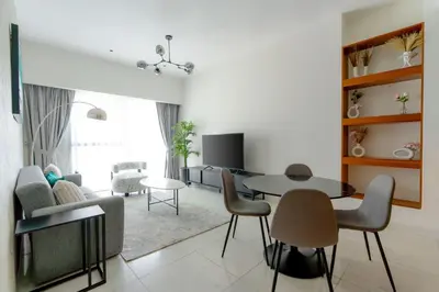 a living room with a table and chairs at Nasma Luxury stays - Executive stay in the Heart of Dubai Financial Hub in Dubai