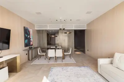 a living room with a white couch and a table at Sea View 2BDR Apartment, Pool and Beach Access in Dubai