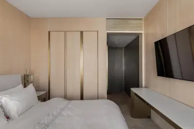 a bedroom with a bed and a television on a wall at Sea View 2BDR Apartment, Pool and Beach Access in Dubai