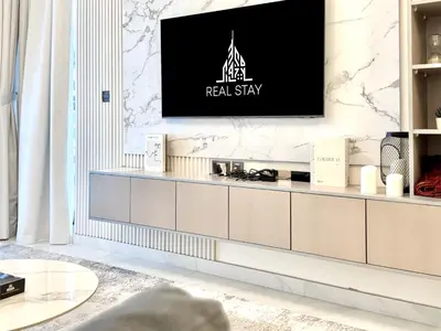 a living room with a television on a wall at Exclusive 4 Months Offer Exclusive 3 bedroom with Private Pool with 1 free houskeeping in Dubai