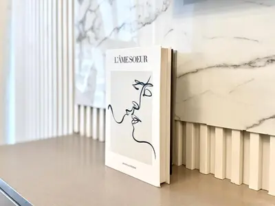 a book sitting on a table next to a wall at Exclusive 4 Months Offer Exclusive 3 bedroom with Private Pool with 1 free houskeeping in Dubai