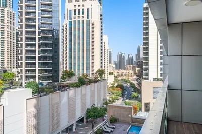 a view of the city from the balcony of a building at Stylish 2BR with Pool, Gym, Sauna & Kid's Playground in Dubai