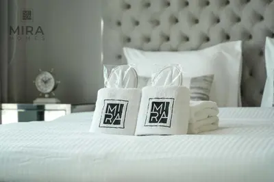 two towels on top of a white bed at Mira Holiday Homes - Lovely and luxury 1 bedroom in Address JBR in Dubai