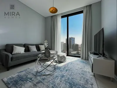 a living room with a couch and a tv at Mira Holiday Homes - Lovely and luxury 1 bedroom in Address JBR in Dubai