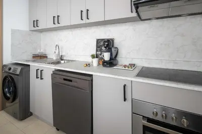 a kitchen with a sink and a dishwasher at Frank Porter - Time Place Tower in Dubai