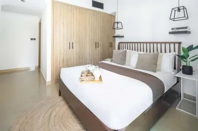 a bedroom with a large bed with a wooden headboard at Frank Porter - Time Place Tower in Dubai