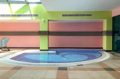 a pool in the middle of a room at Frank Porter - Time Place Tower in Dubai
