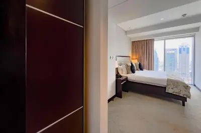 a hotel room with a bed and a large window at Modern 1-Bedroom in Address Marina, City View - 20AB01 in Dubai
