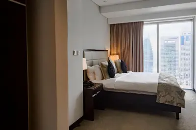 a hotel room with a bed and a large window at Modern 1-Bedroom in Address Marina, City View - 20AB01 in Dubai
