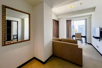 a living room with a couch and a mirror at Modern 1-Bedroom in Address Marina, City View - 20AB01 in Dubai