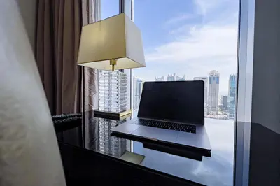 a laptop computer sitting on a desk in front of a window at Modern 1-Bedroom in Address Marina, City View - 20AB01 in Dubai