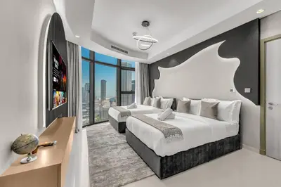 a bedroom with two beds and a large window at Panoramic Burj Views, Famous Infinity Pool, Balcony Mini Golf - Paramount Midtown in Dubai