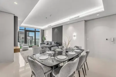 a dining room with a table and chairs at Panoramic Burj Views, Famous Infinity Pool, Balcony Mini Golf - Paramount Midtown in Dubai
