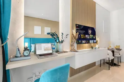 a room with a desk with a laptop and chairs at Luxury Palm Studio, Rooftop Infinity Pool, Beach Access in Dubai