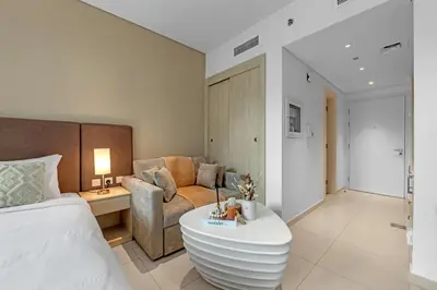 a hotel room with a bed and a couch at Luxury Palm Studio, Rooftop Infinity Pool, Beach Access in Dubai
