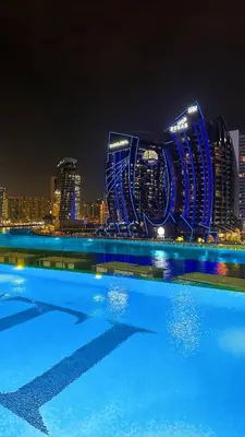 a view of a city skyline at night at Luxury Apt Infinity Pool with Burj View in Dubai