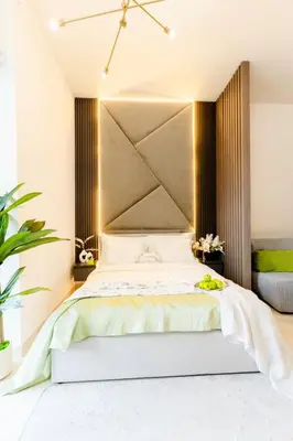 a bedroom with a bed with a large headboard at Luxury Apt Infinity Pool with Burj View in Dubai