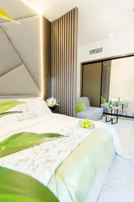a bedroom with a large bed and a couch at Luxury Apt Infinity Pool with Burj View in Dubai