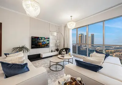 a living room with a view of a city at Livin' Holidays - 2 BR - Burj Khalifa & Fountain in Dubai