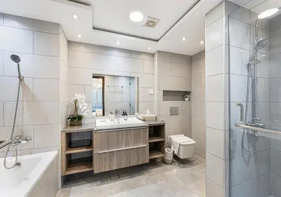 a bathroom with a sink and a shower and a toilet at Livin' Holidays - 2 BR - Burj Khalifa & Fountain in Dubai
