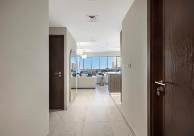 a hallway with a room with a view of a kitchen at Livin' Holidays - 2 BR - Burj Khalifa & Fountain in Dubai