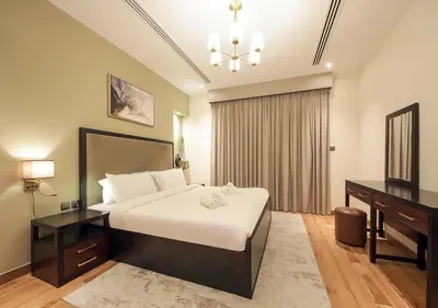 a bedroom with a large bed with a desk and a bed sidx sidx sidx sidx at Stunning 1BR on a High Floor in Dubai Downtown in Dubai