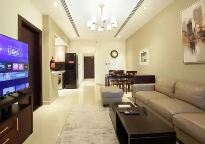 a living room with a couch and a dining room at Stunning 1BR on a High Floor in Dubai Downtown in Dubai