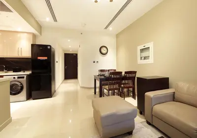 a living room with a couch and a dining room at Stunning 1BR on a High Floor in Dubai Downtown in Dubai
