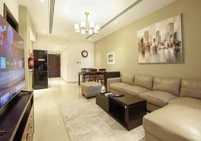 a living room with a couch and a flat screen tv at Stunning 1BR on a High Floor in Dubai Downtown in Dubai