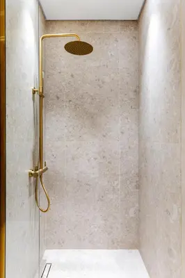a shower with a shower head in a bathroom at Waves - Luxe Studio with Jacuzzi & City Views in Dubai